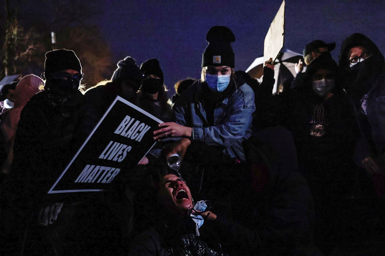 A person gets their eyes washed out after the police released chemical irritants on protesters on Wednesday.