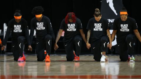 WNBA team the Connecticut Sun kneel during the National Anthem before the game against the Atlanta Dream in August 2020. The WNBA dedicated the season to Breonna Taylor and the Say Her Name movement -- which raises awareness for Black female victims of police violence. They also collectively backed Raphael Warnock in the Georgia senatorial elections against Republican and WNBA team -- the Atlanta Dream -- owner Kelly Loffler.