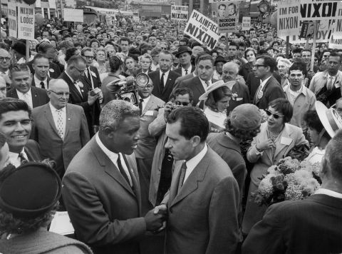 Robinson shakes hands with President Richard Nixon at a GOP rally in 1960. Robinson attended the 1964 Republican Convention, but he later supported Democrats as the political parties' makeup changed.