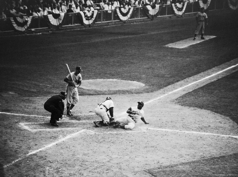 Robinson steals home during Game 1 of the 1955 World Series. The Dodgers lost the game but went on to defeat the New York Yankees in seven games.
