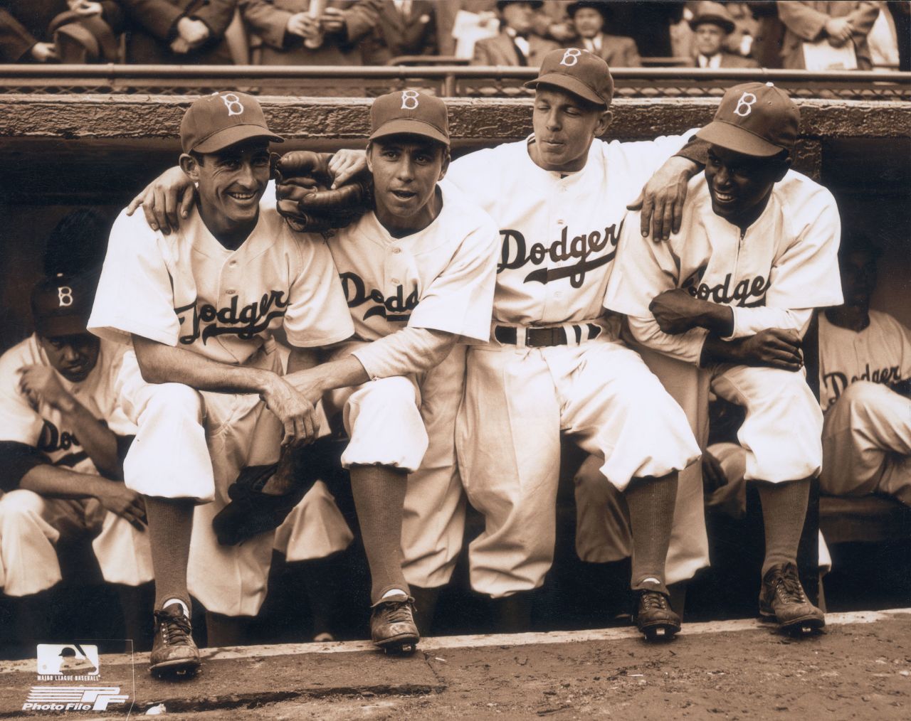 Robinson poses in the dugout with Dodgers teammates as he makes his historic debut on April 15, 1947. With Robinson, from left, are Johnny "Spider" Jorgensen, Harold "Pee Wee" Reese and Eddie Stanky.