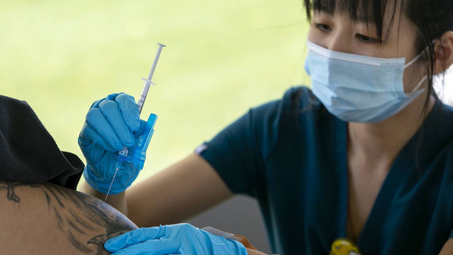 Xinna Chen administers the Moderna Covid-19 vaccine to a patient at the Human Services Campus in Phoenix on April 13, 2021.