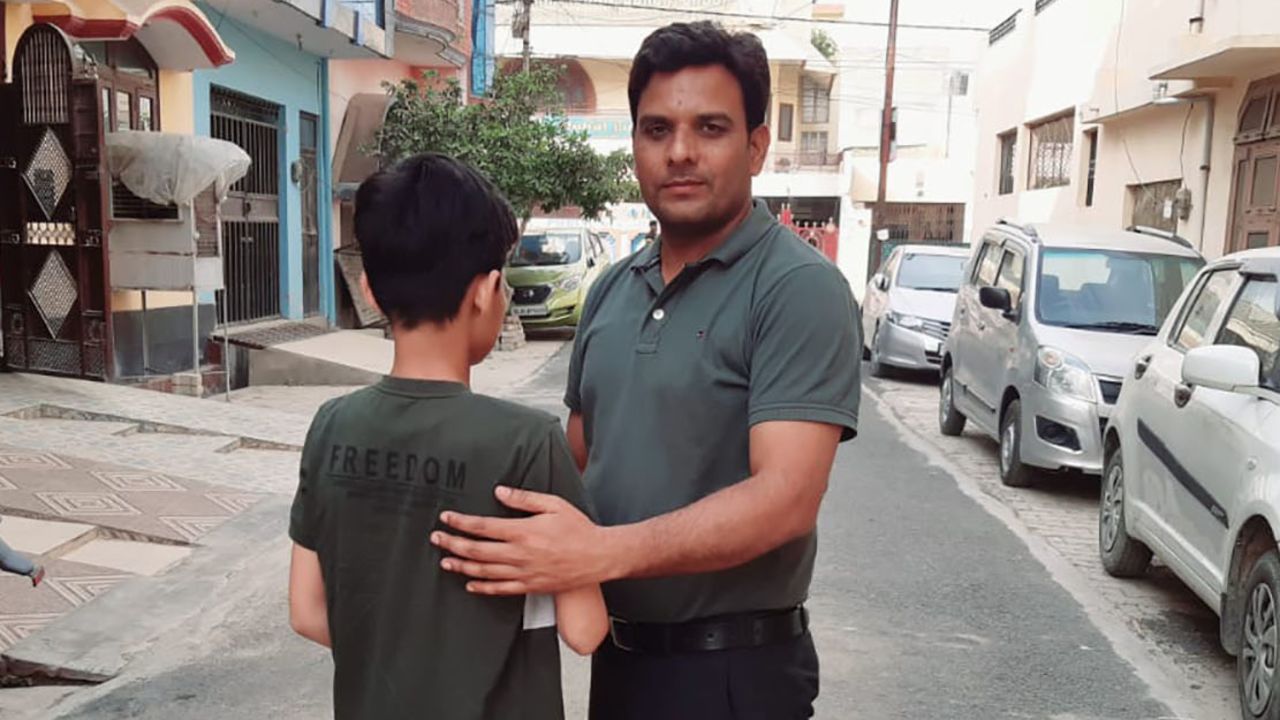 "Bittu," 12, with his foster father and legal guardian, Usman Saifi.