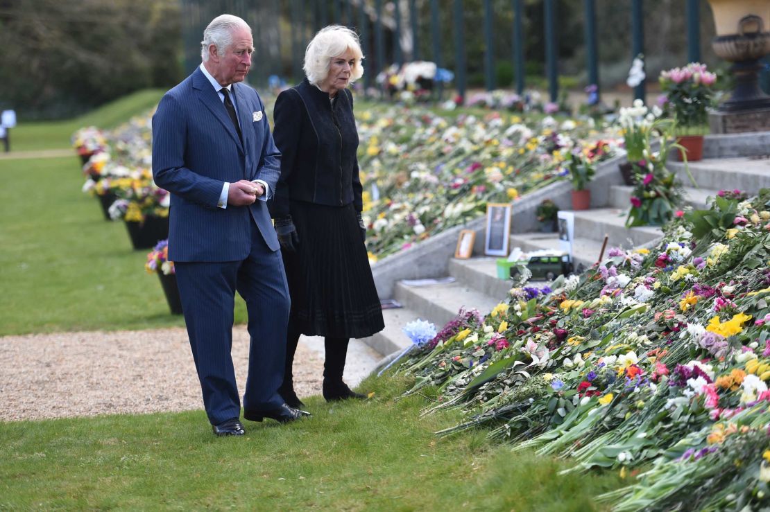 Prince Charles and the Duchess of Cornwall view the flowers and messages of condolence left outside Buckingham Palace.