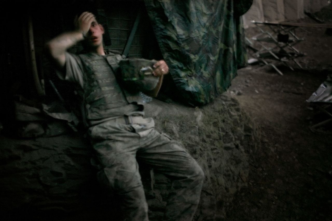 US Army Spc. Brandon Olson sinks onto a bunker embankment in Afghanistan's Korengal Valley in September 2007. The Korengal Valley was the site of some of the deadliest combat in the region.