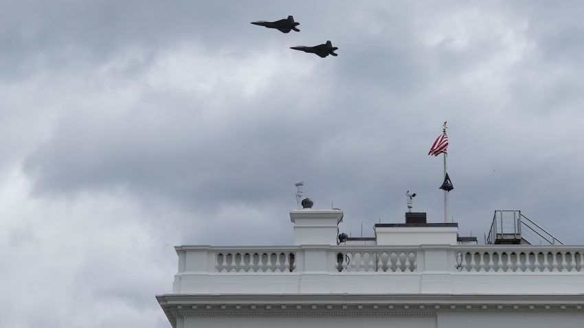 Two military aircraft fly over the White House on April 16, 2021 in Washington, DC. The US Air Force F-22 fighter aircraft flew over Washington as part of the World War I memorial dedication ceremony.
