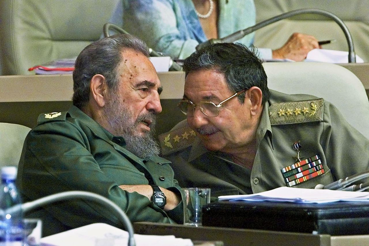 Fidel and Raul Castro confer during a session of the National Assembly in 2001 in Havana.
