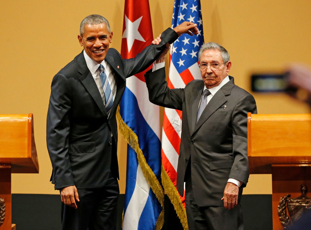 Castro lifts US President Barack Obama's arm after delivering speeches at the Palacio de la Revolución in Havana in 2016. The salute came at the end of a contentious press conference in which members of the press peppered Castro with questions about human rights abuses in the country. Obama was the first sitting US President to visit Cuba since Calvin Coolidge's visit in 1928.