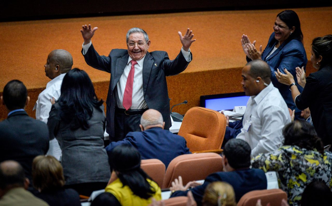 Castro raises his arms in celebration after Miguel Díaz-Canel was elected as the island nation's new president at the National Assembly in Havana in 2018. Castro passed Cuba's presidency to Díaz-Canel, putting the island's government in the hands of someone outside the Castro family for the first time in nearly six decades.