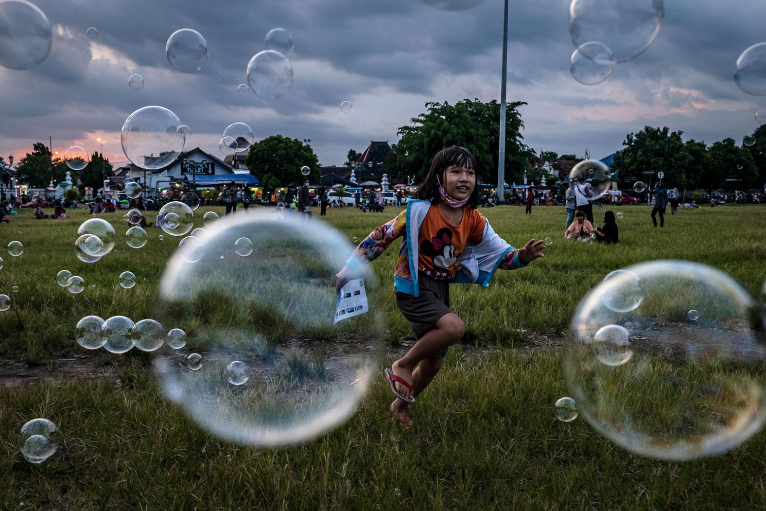 A child plays with soap bubbles as Muslims prepare to break their fast in Yogyakarta, Indonesia.