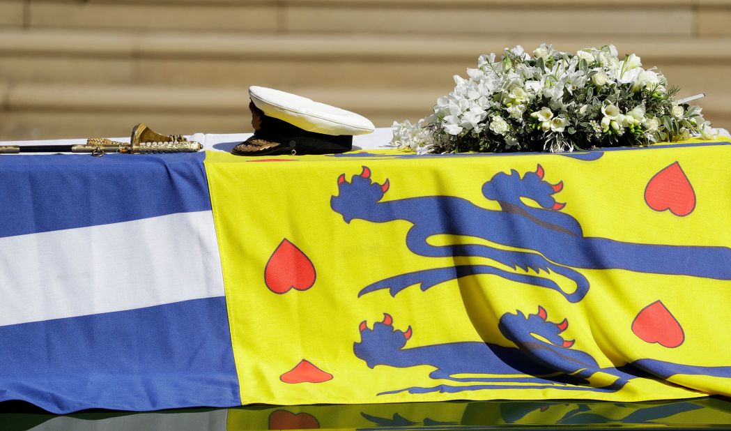 Philip's coffin, draped with his personal flag, had his sword, naval cap and a wreath of flowers laid on top.