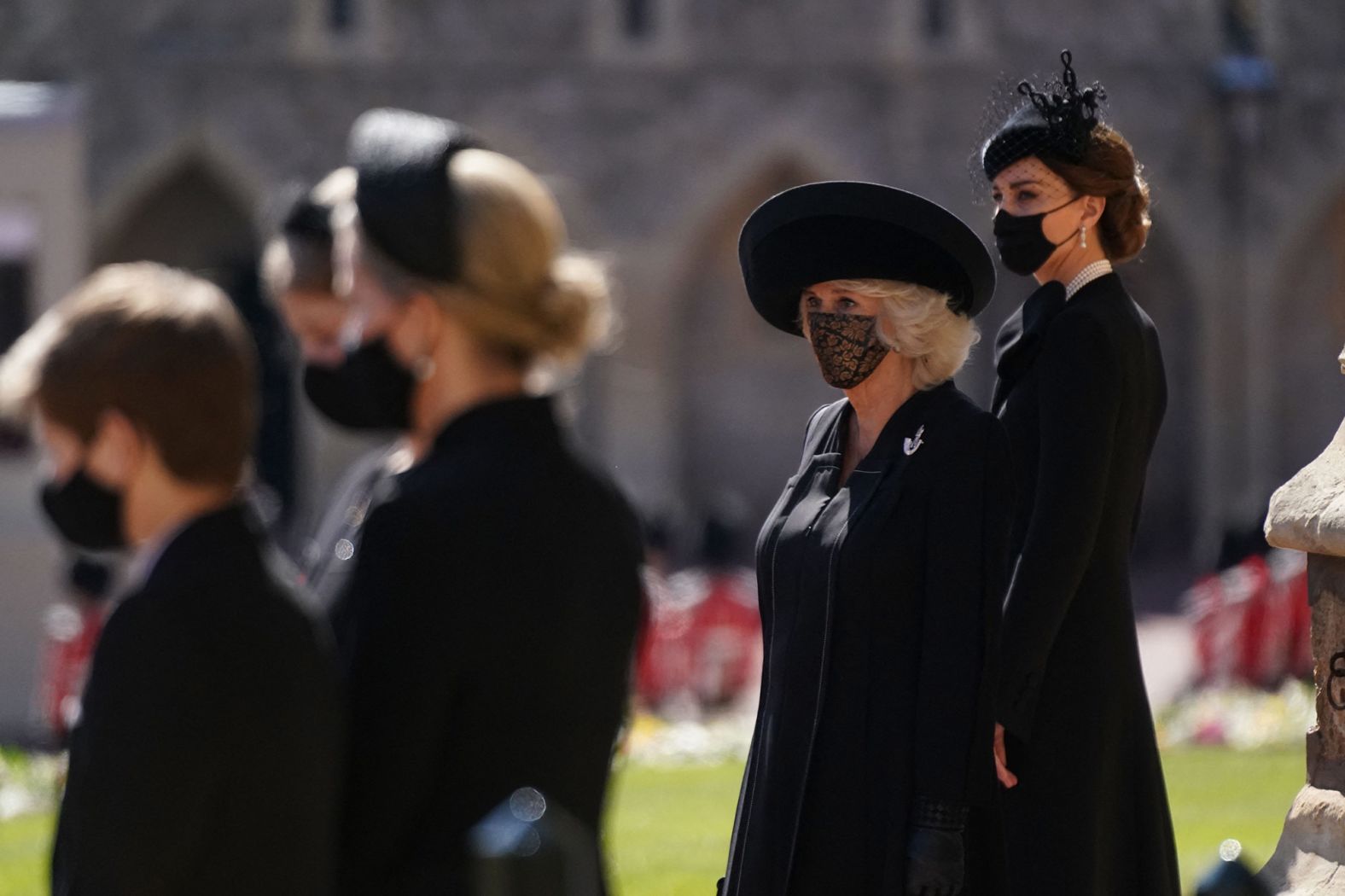 Camilla, the Duchess of Cornwall, and Catherine, the Duchess of Cambridge, stand outside St. George's Chapel before the funeral.
