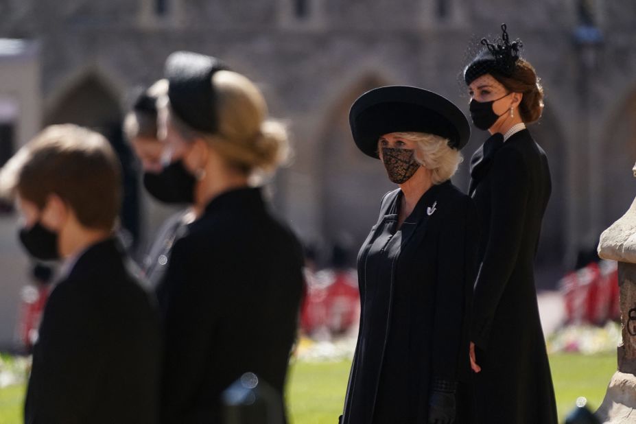 Camilla, the Duchess of Cornwall, and Catherine, the Duchess of Cambridge, stand outside St. George's Chapel before the funeral.