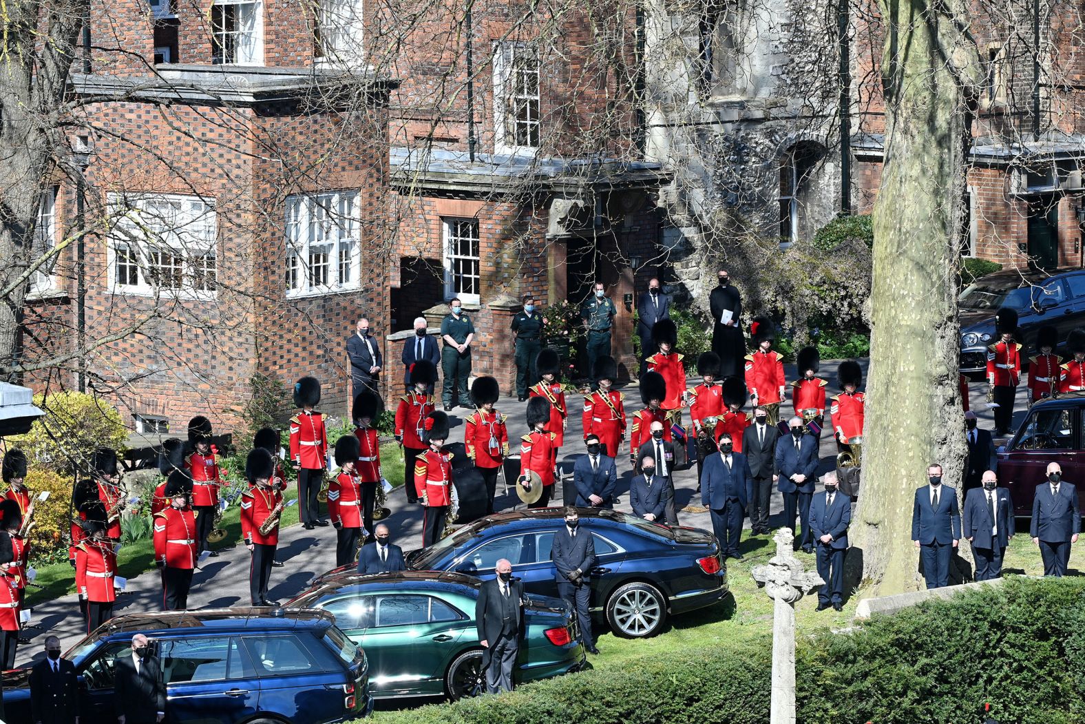 Drivers, Grenadier Guards and royal household staff stand outside during the funeral.