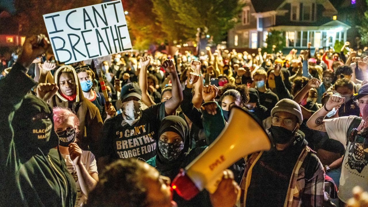 TOPSHOT - Protesters raise their fists during a demonstration after the release on bail of former police officer, Derek Chauvin, in Minneapolis, Minnesota, on October 7, 2020. - The police officer charged with killing George Floyd, the African American whose death sparked a mass protest movement, was released from a Minnesota jail on October 7 on $1 million bail. (Photo by Kerem Yucel / AFP) (Photo by KEREM YUCEL/AFP via Getty Images)