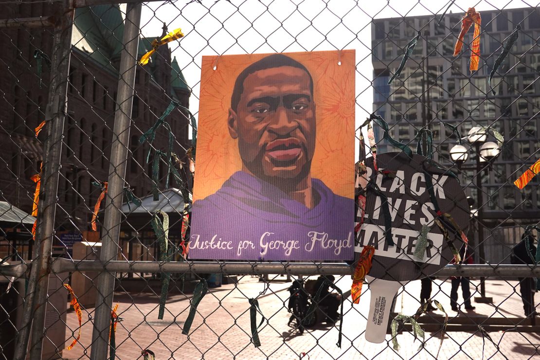 A picture of George Floyd hangs on a fence barrier that surrounds the Hennepin County Government Center on March 30, 2021 in Minneapolis, Minnesota.
