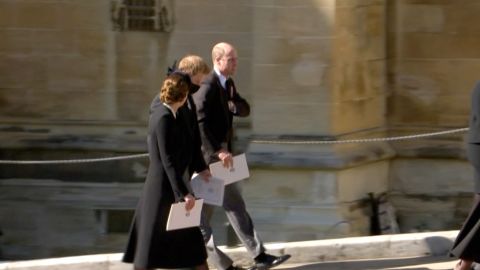 Prince William walks with his brother Prince Harry (center) and wife Catherine, Duchess of Cambridge, after Prince Philip's funeral.