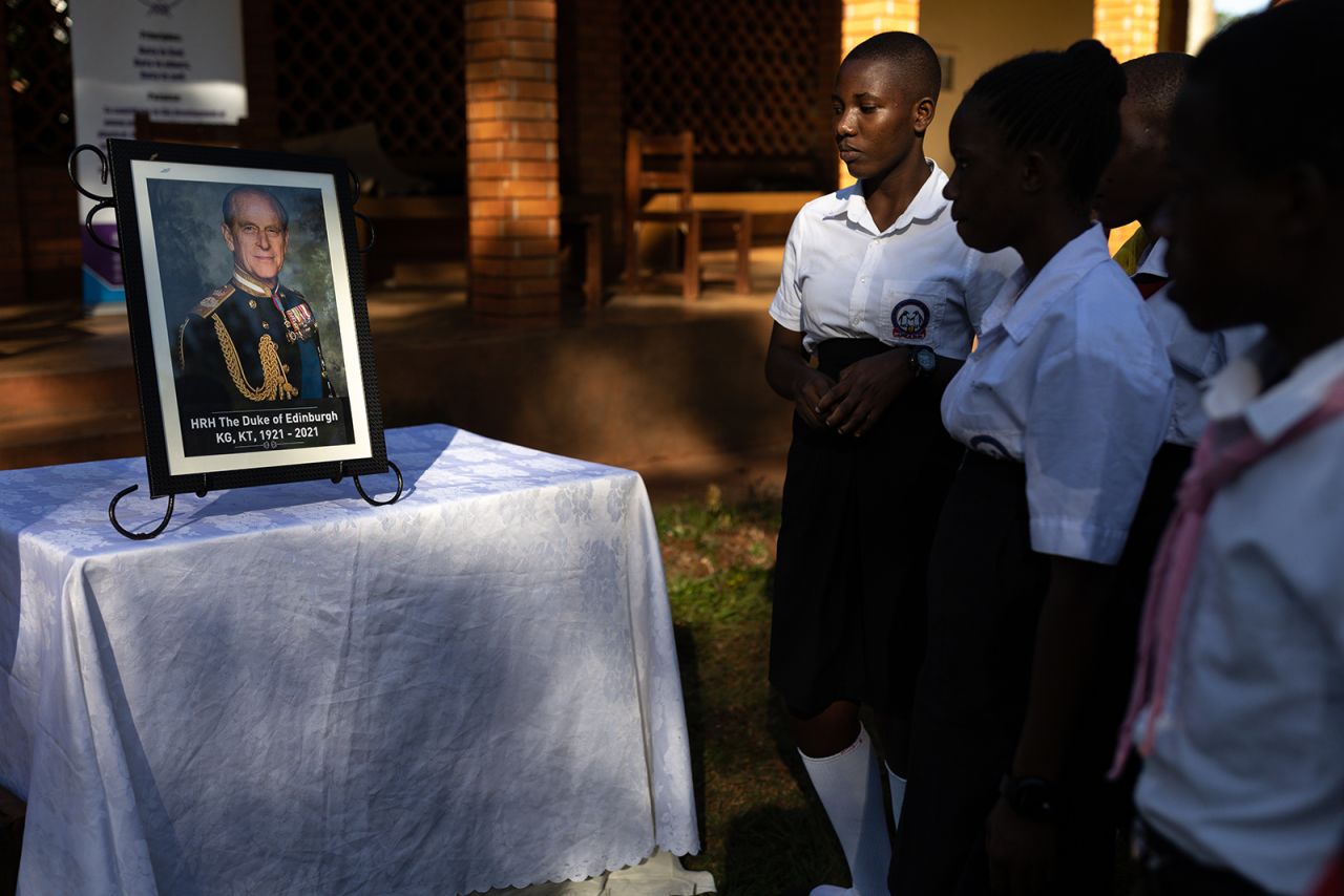 Scouts and Duke of Edinburgh's Award participants look at a picture of Prince Philip in Jinja, Uganda. 