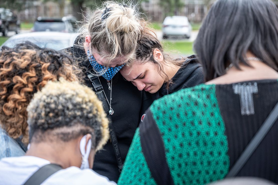 Mourners cry while gathering for a prayer vigil at Olivet Missionary Baptist Church in Indianapolis on Saturday, April 17, in the wake of a mass shooting at a FedEx facility that left at least eight people dead.