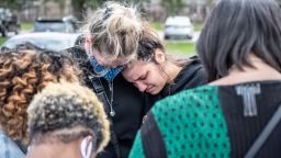 INDIANAPOLIS, IN - APRIL 17: Groups of mourners cry while gathering for a prayer vigil at Olivet Missionary Baptist Church April 17, 2021 in Indianapolis, Indiana. The vigil was held in the wake of a mass shooting at a FedEx Ground Facility that left at least eight people dead and five wounded on the evening of April 15. Police have identified the suspect as former FedEx employee, Brandon Scott Hole, who died of an apparent self-inflicted gunshot wound after the shooting. (Photo by Jon Cherry/Getty Images)