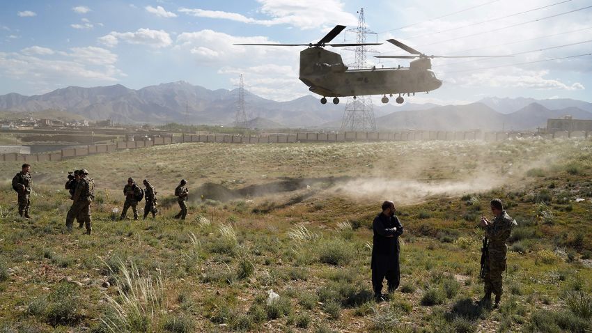 In this photo taken on June 6, 2019, a US military Chinook helicopter lands on a field outside the governor's palace during a visit by the commander of US and NATO forces in Afghanistan, General Scott Miller, and Asadullah Khalid, acting minister of defense of Afghanistan, in Maidan Shar, capital of Wardak province. - A skinny tangle of razor wire snakes across the entrance to the Afghan army checkpoint, the only obvious barrier separating the soldiers inside from any Taliban fighters that might be nearby. (Photo by THOMAS WATKINS / AFP) / To go with 'AFGHANISTAN-CONFLICT-MILITARY-US,FOCUS' by Thomas WATKINS        (Photo credit should read THOMAS WATKINS/AFP via Getty Images)
