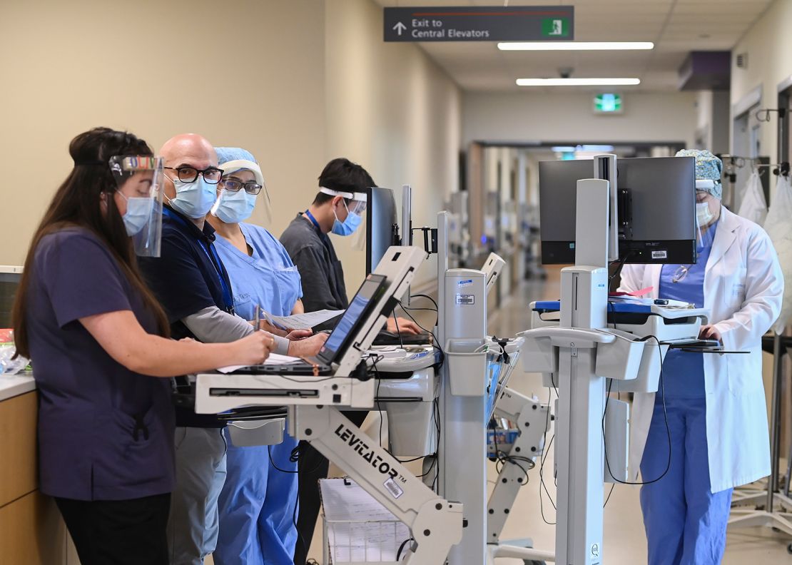 Head intensivist Dr. Ali Ghafouri, second left, meets with his team in the intensive care unit at the Humber River Hospital in Toronto on Tuesday, April 13, 2021.