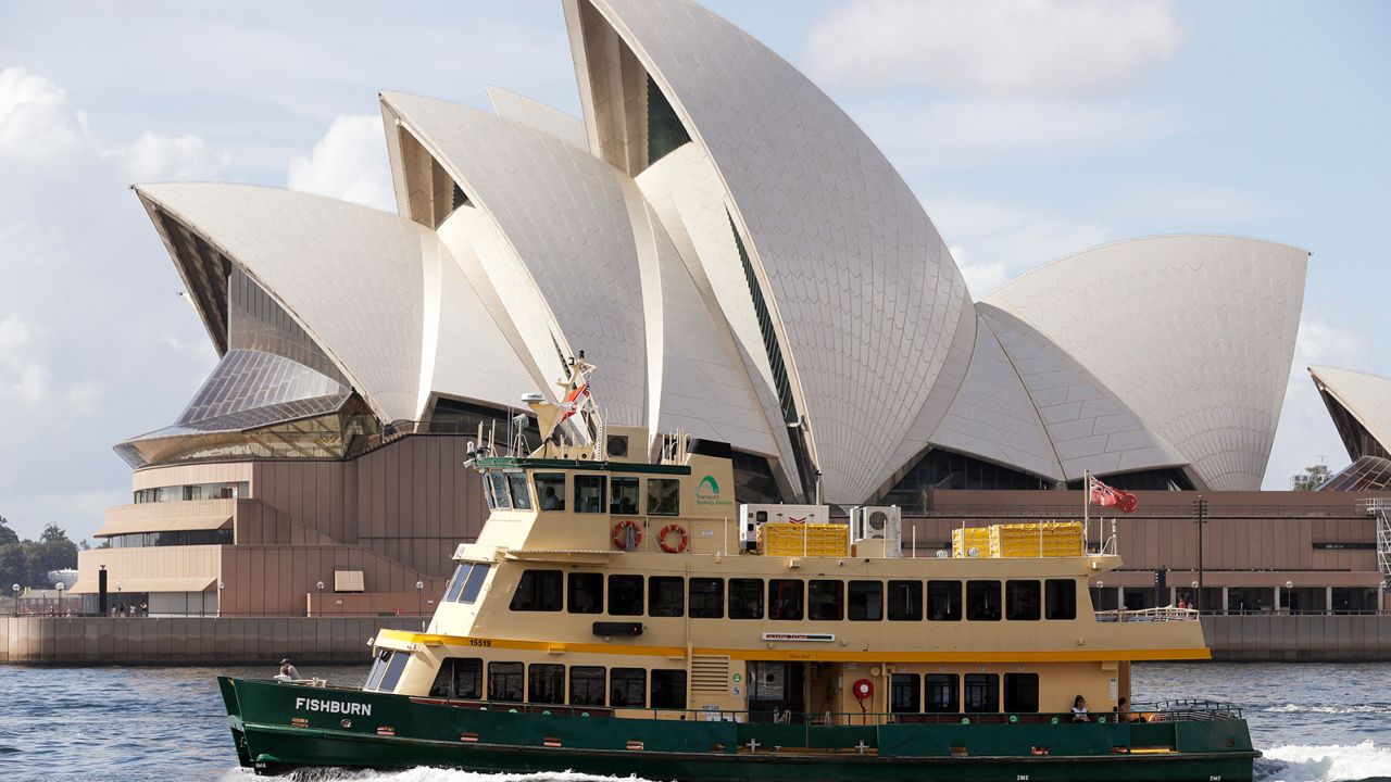 A ferry sails past the Opera House in Sydney, Australia, Tuesday, April 6, 2021. New Zealand announced the start date for a long-anticipated travel bubble between Australia and New Zealand that will allow people to travel between the two countries without going through quarantine, allowing families to reunite and giving a big boost to the struggling tourism industry will begin April 19. (AP Photo/Rick Rycroft)