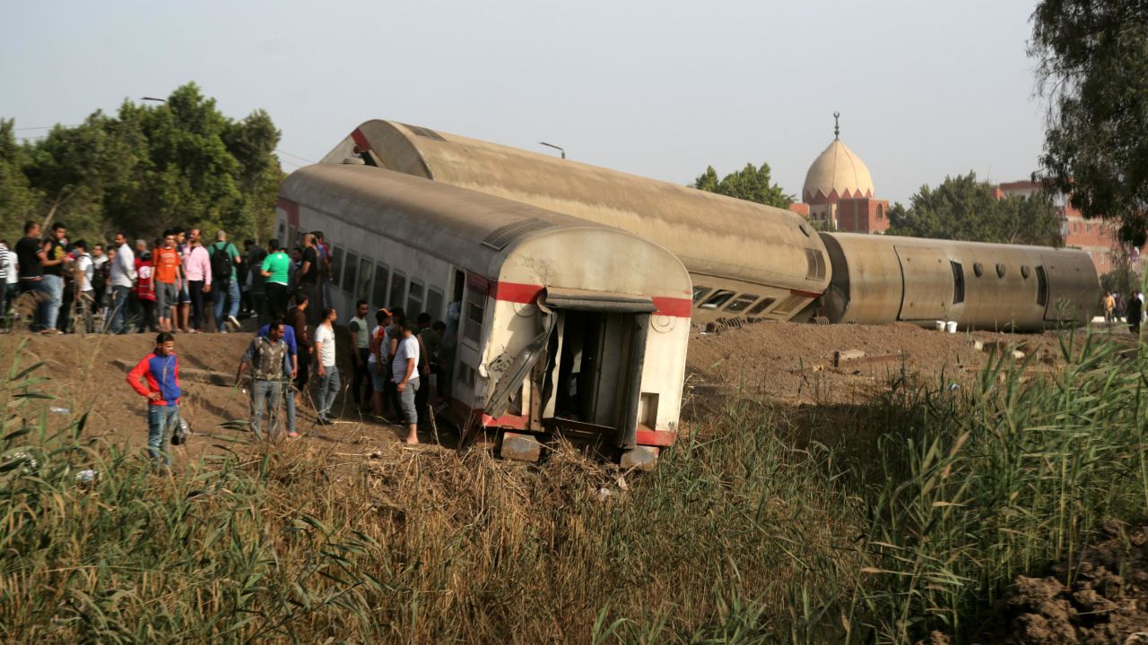 People gather at the site of the train accident in Qalioubia province, north of Cairo.