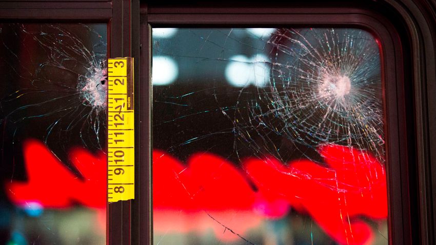 EDITORS NOTE: Graphic content / Damaged glass and adhesive measuring tape is pictured on a bus window at the scene of a shooting that left one person dead and seven injured, including a child, in downtown Seattle, Washington on January 22, 2020. - At least one person was killed and seven others, including a child, were wounded on Wednesday after gunfire broke out in downtown Seattle near a popular tourist area, police and hospital officials said. Police said at least one suspect was being sought in connection with the mass shooting that took place near a McDonald's fast food restaurant, just blocks away from the Pike Place Market. (Photo by Jason Redmond / AFP) (Photo by JASON REDMOND/AFP via Getty Images)