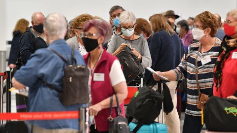 Passengers wait at the check-in counters for New Zealand flights at Sydney International Airport on April 19, 2021, as Australia and New Zealand opened a trans-Tasman quarantine-free travel bubble.