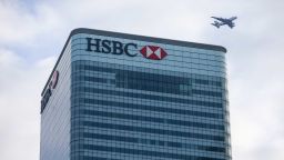 An aircraft passes over the top of the global headquarters for HSBC Holdings Plc in Canary Wharf financial, business and shopping district, in London, U.K., on Thursday, Jan. 7, 2021. Persimmon Plc, the U.K.s biggest housebuilder, said the long-term outlook for the countrys housing market remained resilient despite the economic gloom and latest national lockdown. Photographer: Hollie Adams/Bloomberg via Getty Images