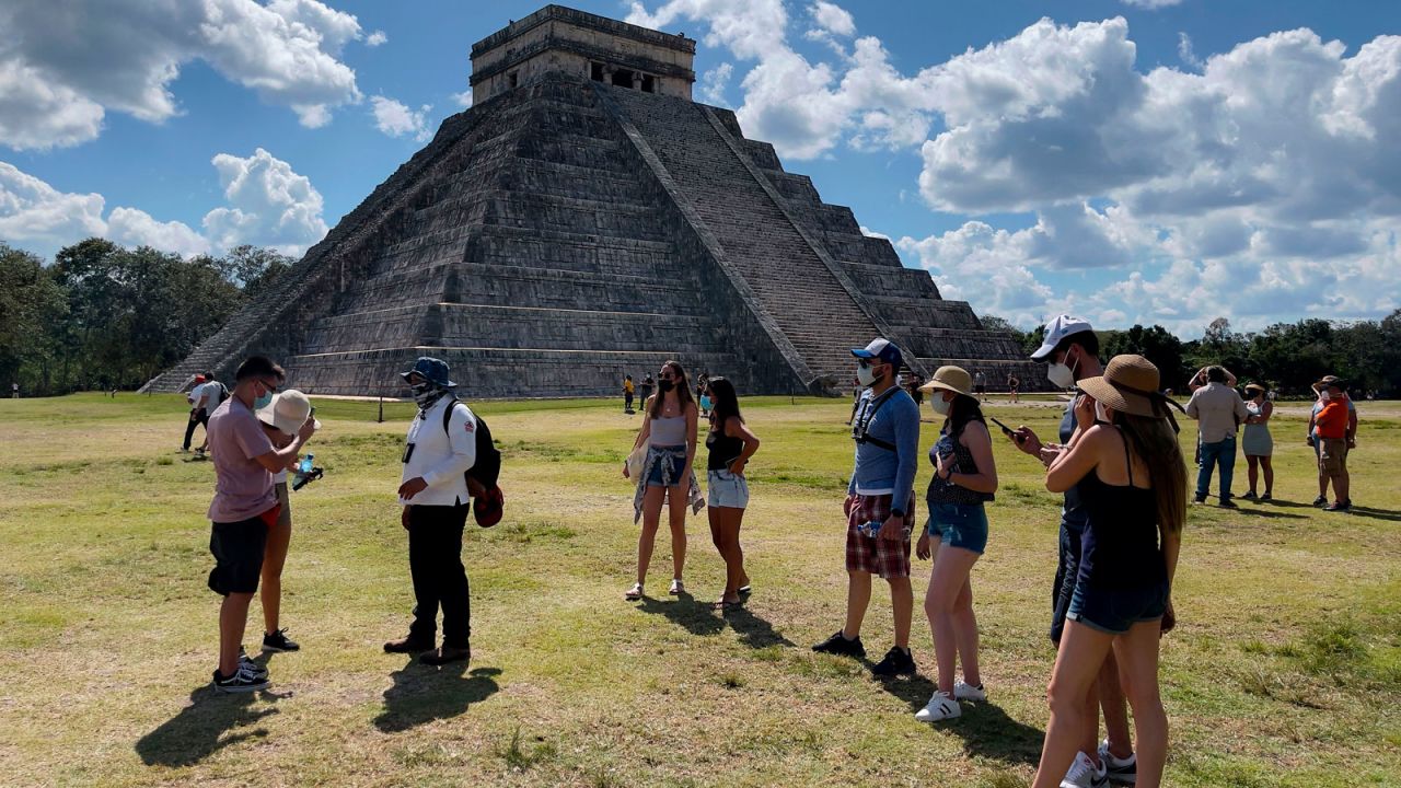 These tourists are wearing face masks, but police have complained that some visiting Mexico's Chichen Itza ruin site are not.