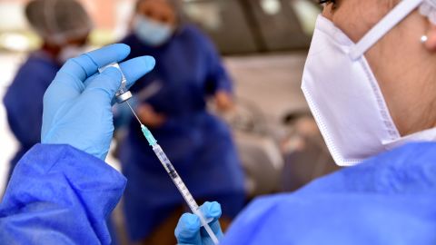 A health worker prepares a dose of the Pfizer-BioNTech Covid-19 vaccine at a drive-thru vaccination center in of Bogota, Colombia.