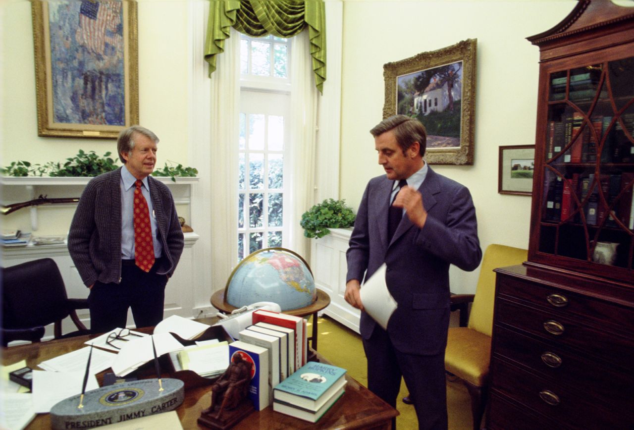 President Carter speaks with Vice President Mondale in the Oval Office in Washington, DC, in May 1977. They defeated the Republican ticket, Gerald Ford and Bob Dole, in the 1976 election.