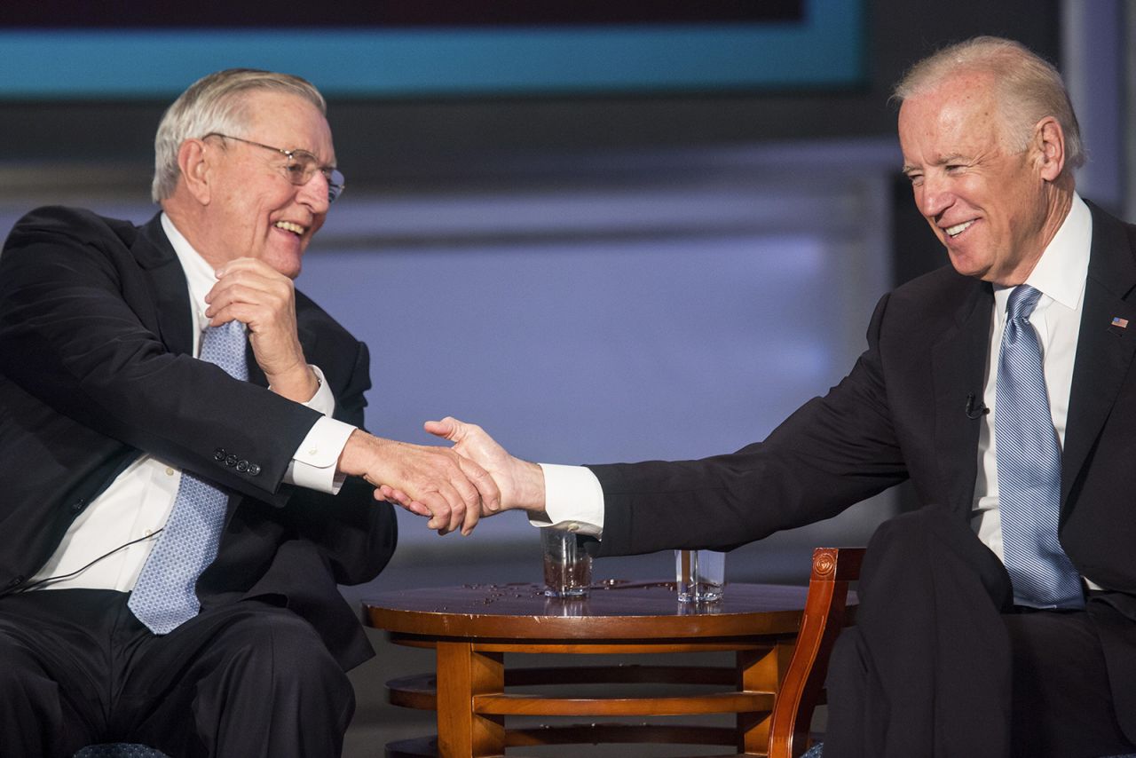 Then-Vice President Joe Biden and Mondale shake hands during an event honoring Mondale at The George Washington University in Washington, DC, on October 20, 2015.