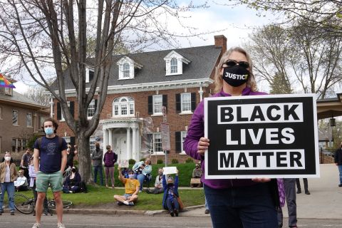 Demonstrators gather outside the home of Minnesota Gov. Tim Walz in St. Paul, for a rally and march against police brutality on April 18.