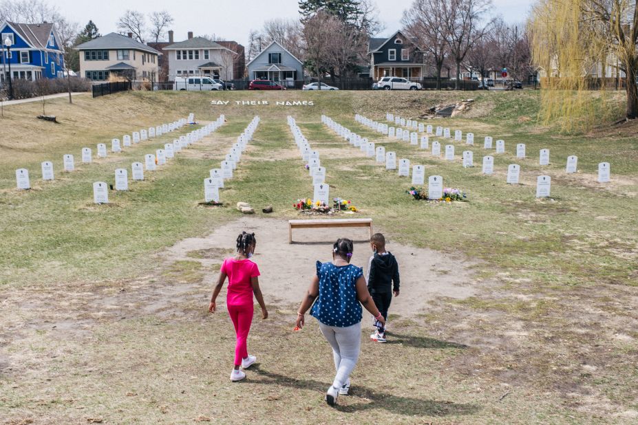 Children walk at a memorial in Minneapolis on Sunday, April 4. The "Say Their Names" symbolic cemetery memorializes Black lives lost at the hands of police.