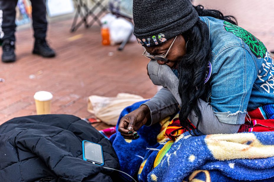 An activist cries as she listens to testimony outside the courthouse in Minneapolis on March 30.