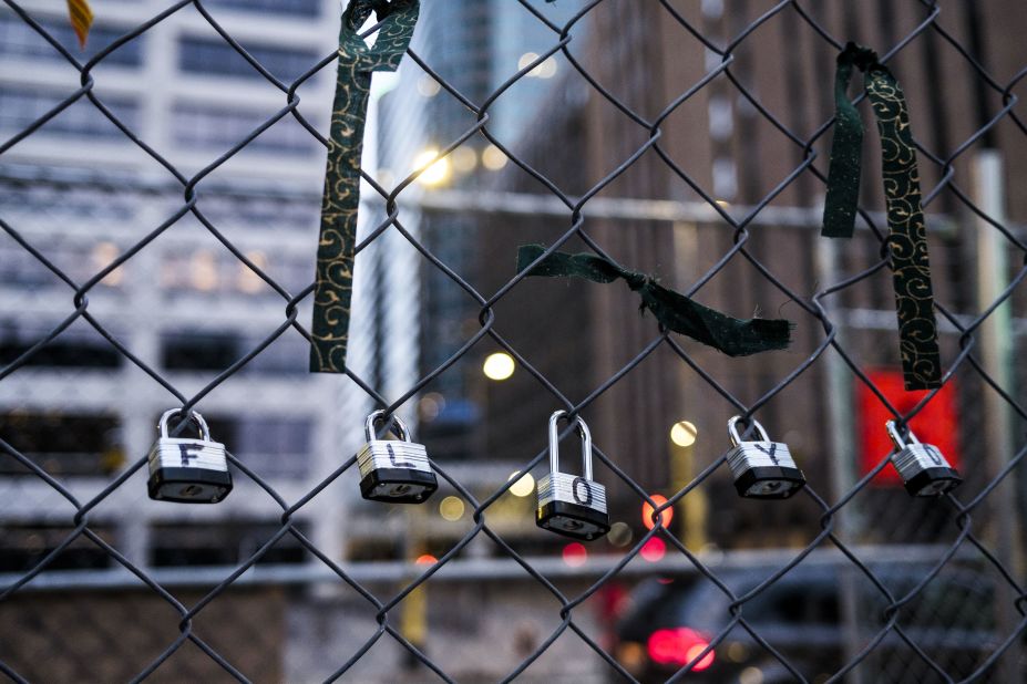 Locks spelling out George Floyd's name are linked to the fencing set up outside the courthouse on March 30.