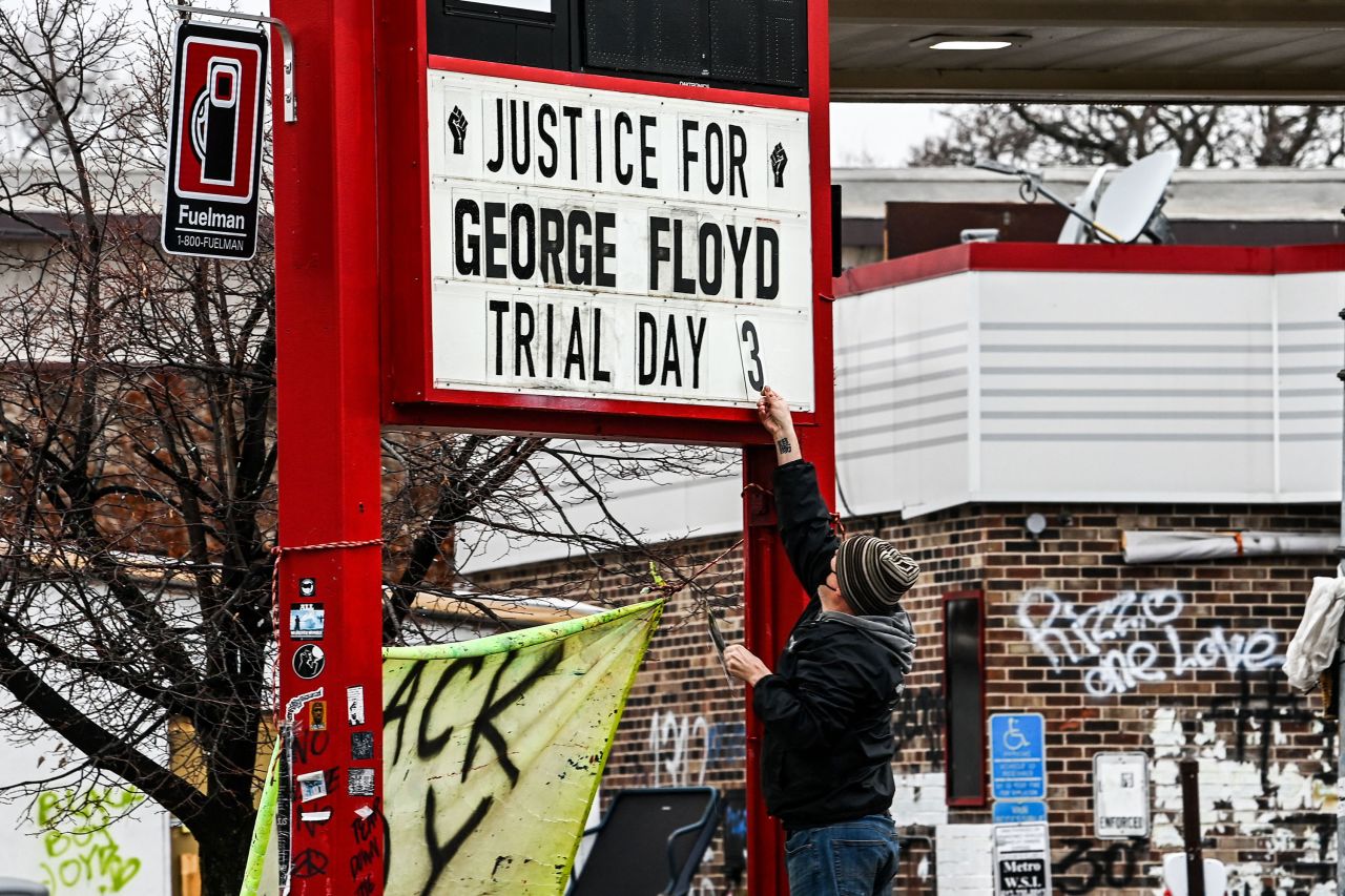 A man changes the number of a sign board at a makeshift memorial for Floyd in Minneapolis on March 10.
