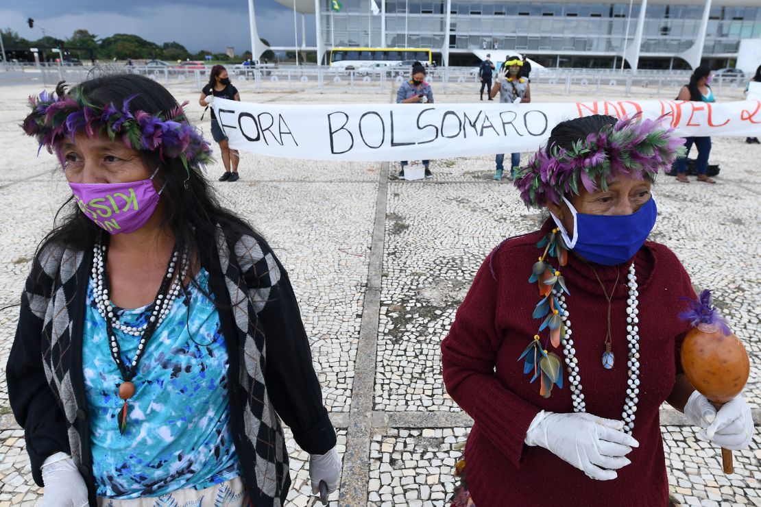 Brazilian indigenous people from various ethnic groups protest against the proposal of the federal government to legalize mining in indigenous lands, in front of Planalto Palace in Brasilia on April 19, 2021. 