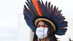 An indigenous woman takes part in a protest along with people from various ethnic groups in a protest against the proposal of the federal government to legalize mining in indigenous lands, in front of Planalto Palace in Brasilia on April 19, 2021. - As Indigenous Day is celebrated in Brazil on April 19, the protesters criticized the policies of President Jair Bolsonaro's government and the withdrawal of their rights guaranteed in the constitution. (Photo by EVARISTO SA / AFP) (Photo by EVARISTO SA/AFP via Getty Images)