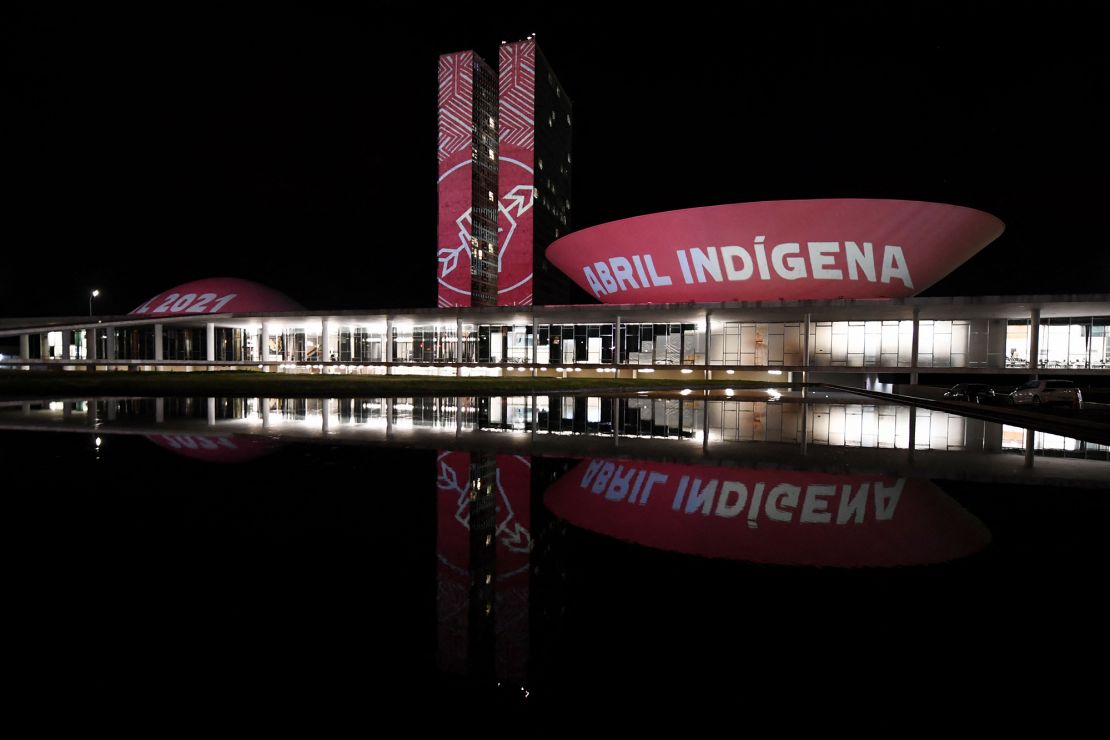 Members of the Articulation of Indigenous Peoples of Brazil (APIB), project the phrase "Indigenous April" at the National Congress in Brasilia during Indigenous Day, on April 19, 2021.