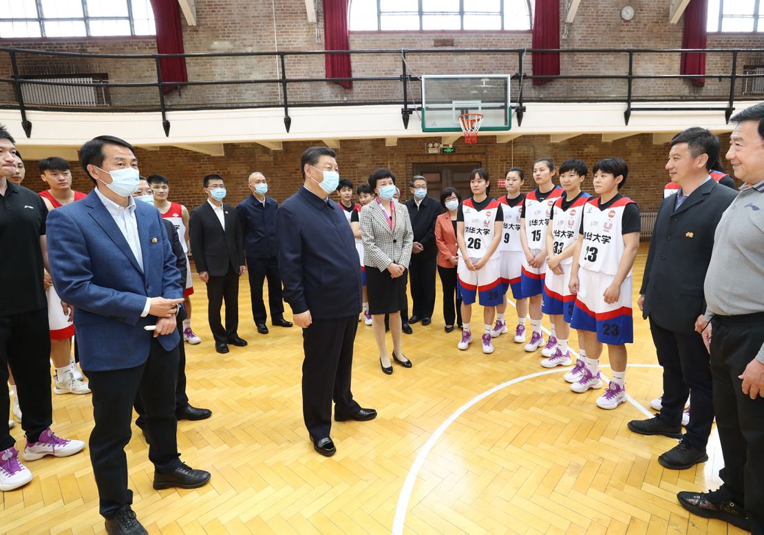 Xi talks to basketball players at Tsinghua University, where he called on the school to cultivate students who are both "red and professional."