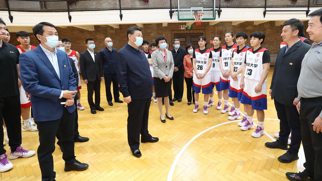 Xi talks to basketball players at Tsinghua University, where he called on the school to cultivate students who are both "red and professional."