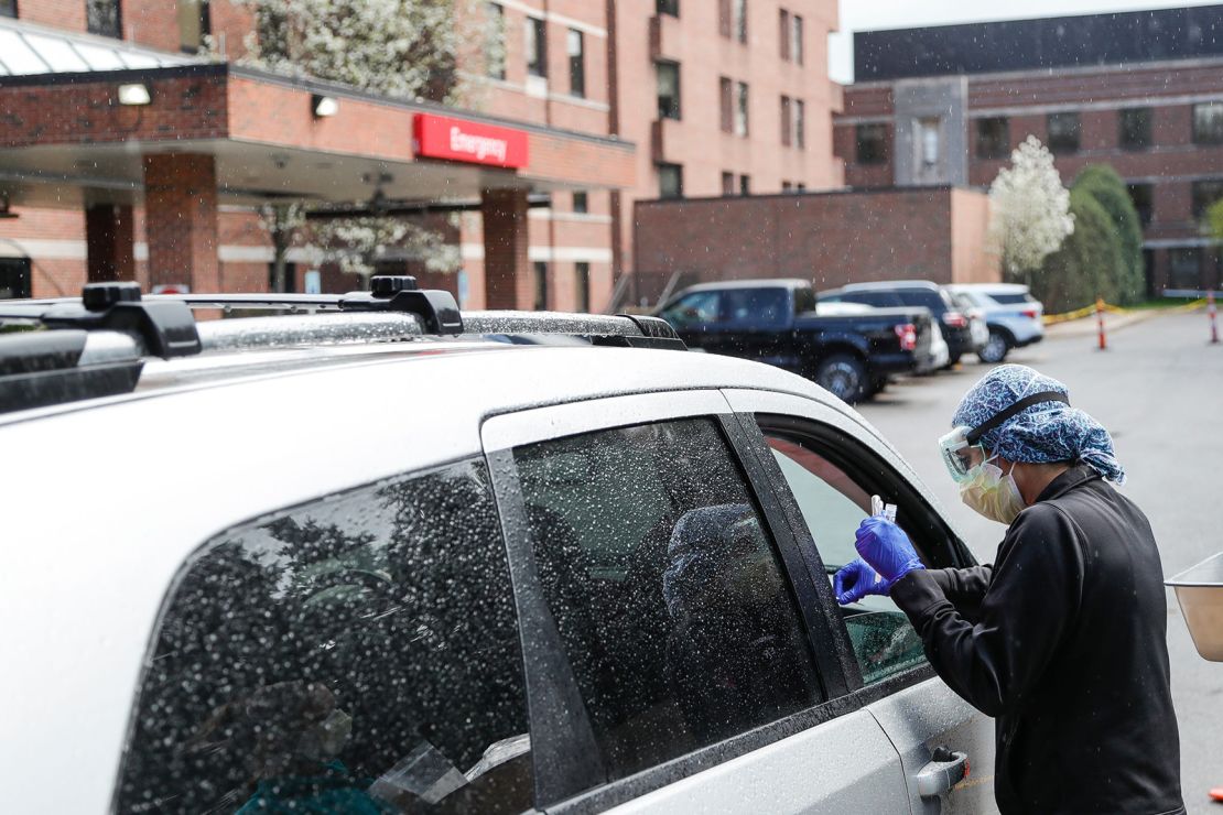 An ER technician tests patients for Covid-19 outside of the emergency entrance of Beaumont Hospital in Grosse Pointe, Michigan, on April 15, 2021