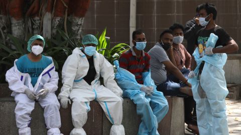 Health workers rest in between cremating Covid-19 victims in New Delhi, India, on April 19.