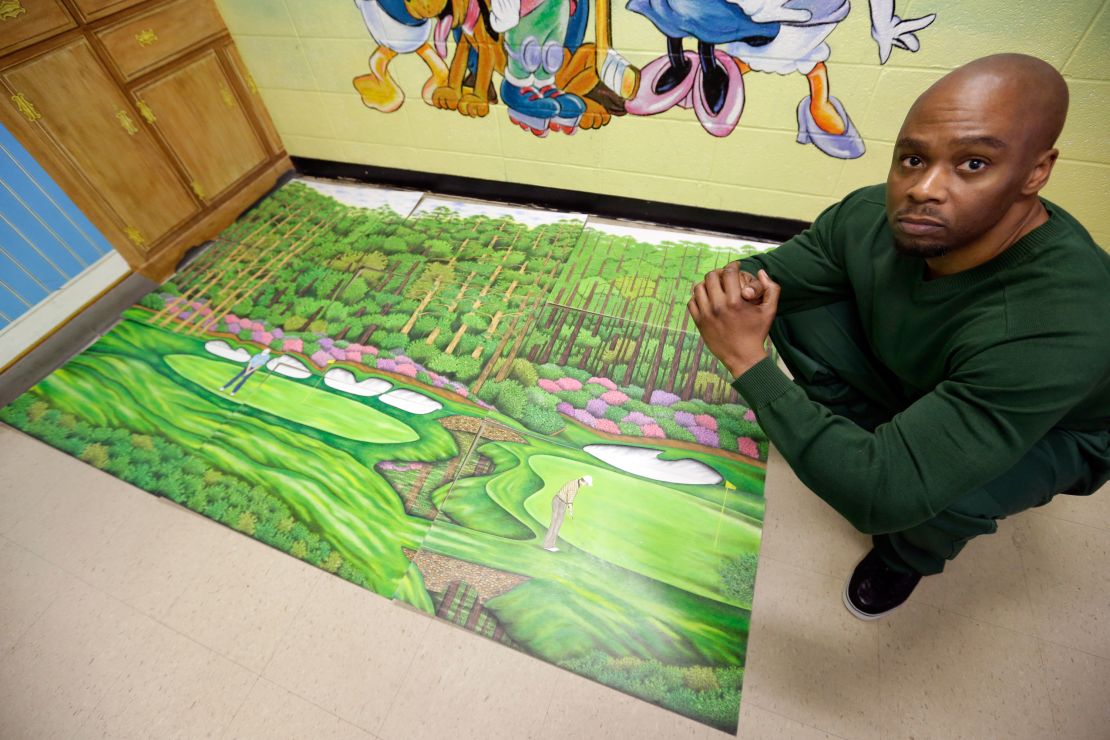 Attica Correctional Facility inmate Dixon poses with his golf art he created in prison.