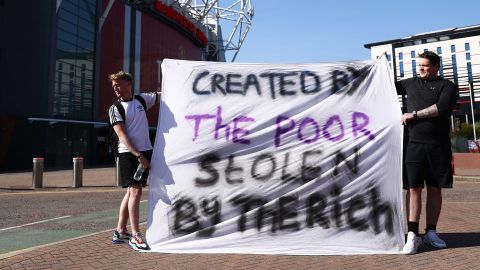 Football fans opposing the European Super League outside Old Trafford in Manchester.