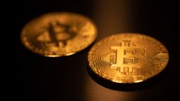 Bitcoin golden physical coin illustration on dark black background with reflection. Visual representations of the digital Cryptocurrency Bitcoin. Bitcoin with the symbol BTC, XBT is a popular digital currency that showed growth and is widely spread, accepted from banks, markets and other services and shops as ways of payments. The exchange rate today for 1 bitcoin blockchain is 55.883 US Dollar. Bitcoin is traded in historical record prices touching almost $60000  in the markets. Eindhoven, the Netherlands on March 27, 2021 (Photo by Nicolas Economou/NurPhoto via Getty Images)